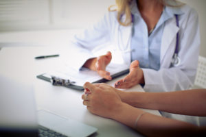 doctor talking with female patient